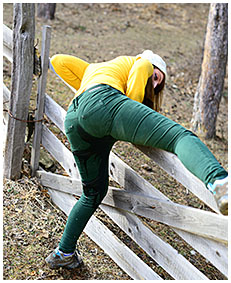 gemma climbs fence pees green jeans 03
