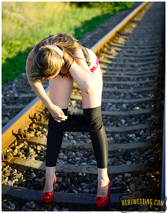 Shiny wet tights on the railroad