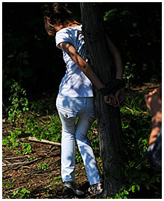 Bound to a tree Natalie wets her white jeans