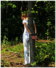 peeing in white jeans while she is tied to a tree 05
