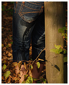 girl wets herself bound to a tree going in her jeans